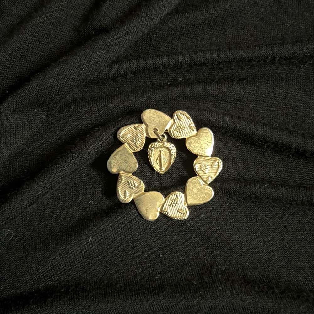 Beautiful pin with hearts and Virgin Mary charm.